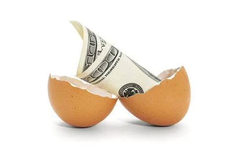 Eggshell with 100 dollar bank note Stock Photos