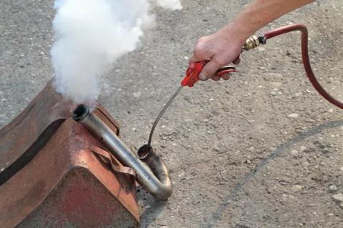 EGR intake pipe cleaning using fire Stock Photos