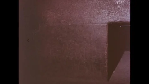 Egypt 1970s: A dimly lit, empty room featuring a large, rectangular stone block Stockbeeldmateriaal 309895192