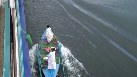 Egypt 22 Dec 2019 Tiny boats attaching tourist cruise ships along the Nile ri Stock Footage 141315179