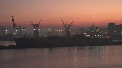Egypt, Port Alexandria harbor early dawn, cranes and ships, dolly Stock Footage