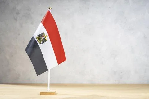 Egypt table flag on white textured wall. Copy space for text, designs or 스톡 일러스트