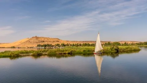 Egyptian feluka, small sailingboat at the baks of river Nile Stock Photos