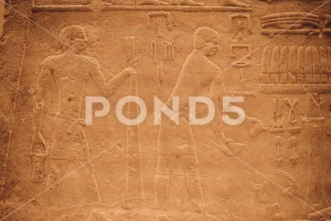 Egyptian Hieroglyphic carvings on the exterior walls of an ancient temple Stock Photos