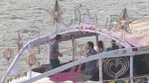 Egyptian men on ferry going down the Nile River Stockbeeldmateriaal 82315025