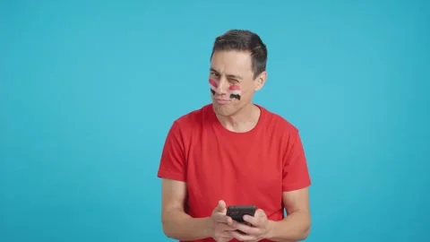 Egytp supporter looking at his mobile smiling and showing it. Stock Footage 254321133