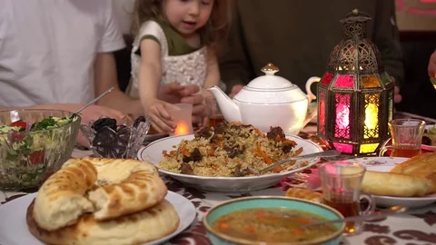 Eid Mubarak. Muslim people eating food during Iftar at home Stock Footage