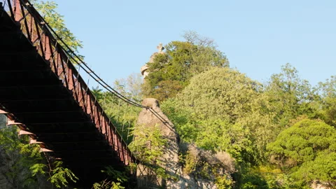 Eiffel Suspension Bridge and Temple de la Sibylle Landmark at Parc des Buttes-Ch Stock Footage 338383571