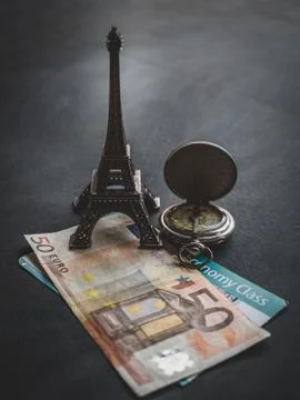 Eiffel tower with 50 euro banknote and boarding pass Stock Photos