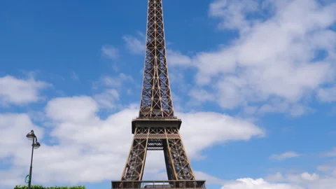 The Eiffel tower and blue sky tilt down slow motion shot. Paris, France. Stock Footage 260698562