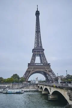 Eiffel Tower and bridge over the Seine River in Paris Stock Photos