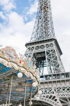 Eiffel Tower and carousel during a sunny day in Paris, France Stock Photos