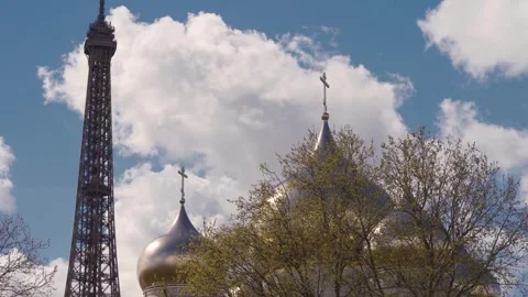 Eiffel Tower And Holy Trinity Cathedral Golden Dome Against Cloudy Blue Sky Stock Footage 339661369