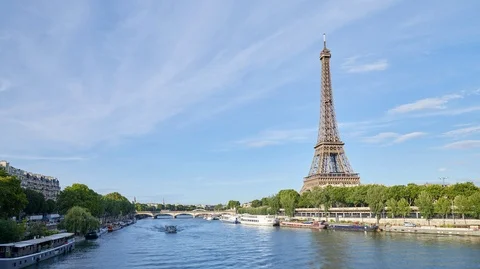 Eiffel Tower and Seine river in Paris in a sunny day in France, blue sky Stock Footage 126528059