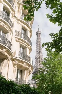 The eiffel tower between the buildings Stock Photos