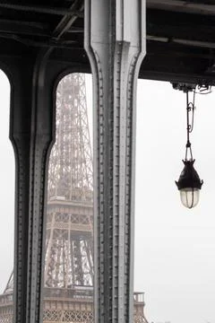 The Eiffel Tower between the colones of the Bir Hakeim bridge in the rain Stock Photos