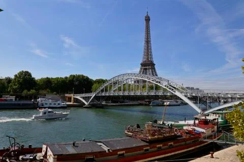 Eiffel Tower &amp; blue sky with clouds, Paris, France - view from water with arched Stock Photos