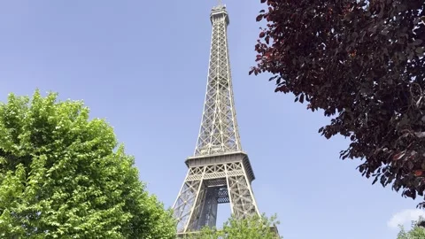 Eiffel Tower from Champ de Mars in Paris, France on a clear spring day Stock Footage 337196685