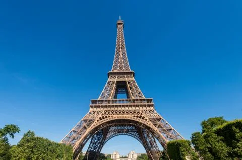 Eiffel Tower from the Champ de Mars gardens in summer. Stock Photos