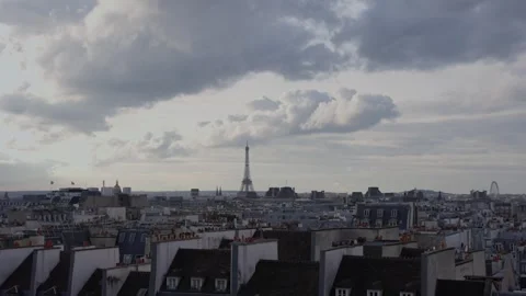 Eiffel Tower on a cloudy summer day and the roofs of the city of Paris. Zoom in Stock Footage 257072461