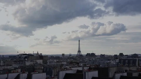 Eiffel Tower on a cloudy summer day and the roofs of the city of Paris. Stock Footage 257600920