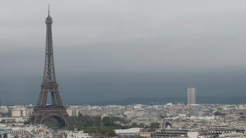 Eiffel Tower, distant skyscraper and skyline of cloudy Paris, wide view Stock Footage 290882059