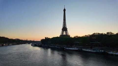 Eiffel Tower at Dusk Overlooking the Seine River and Boats in Paris Cityscape Stock Footage 335191291