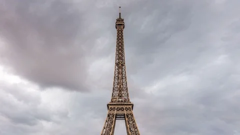 Eiffel tower at dusk, Paris. Dark clouds move across the sky. Zoom out. Stock Footage 87288407