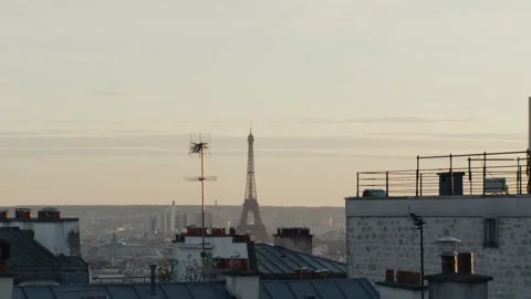 Eiffel tower emerging from parisian rooftops at dawn Stock Footage 306462535