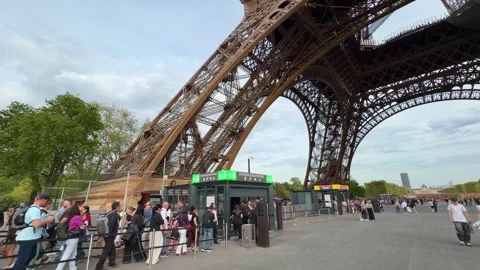 Eiffel Tower entrance with queue of tourists in Paris Stock Footage 334119308