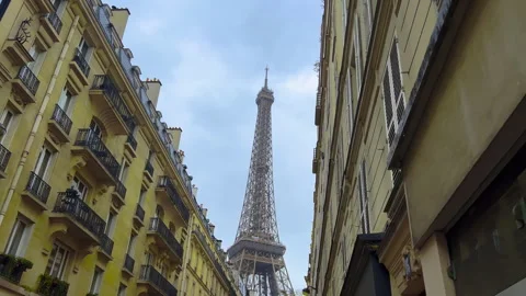 The Eiffel Tower in the evening can be seen between the buildings, the camera Stock Footage 240999710