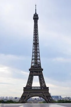 Eiffel Tower full height view against cloudy sky in Paris Stock Photos
