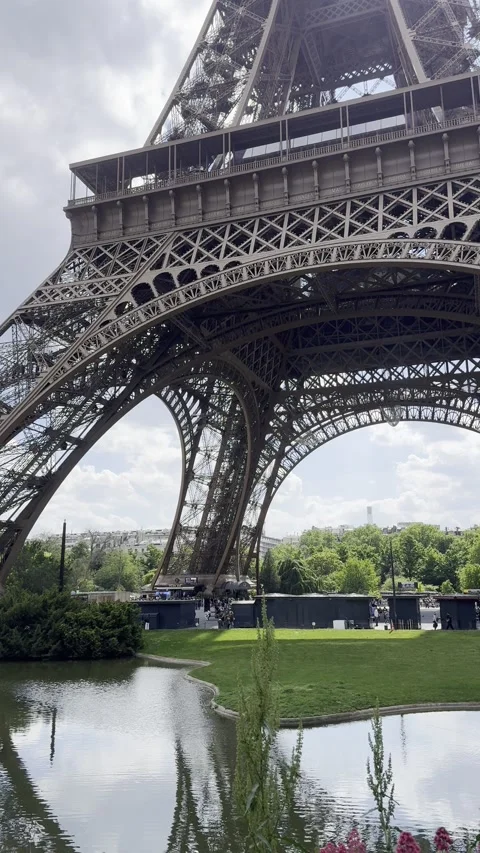 Eiffel Tower with gardens and pond in Paris, France during spring Stock Footage 337196827