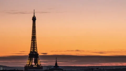 The Eiffel Tower at an incredibly fine and multicolored sunset at midnight in Video stock 99134764