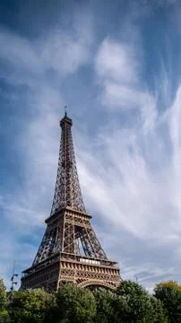 Eiffel Tower lower ⅔ vertical wispy clouds blue sky Fotos de archivo