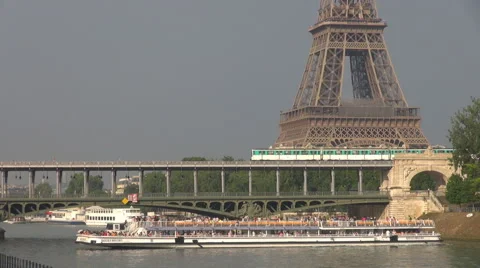 Eiffel Tower metro train pass bridge cruise ship turn around sunny day Paris Stock Footage 44399870