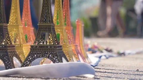 Eiffel Tower Mini Souvenirs In Paris Street Scene With Tourists Walking By Stock Footage 335167355