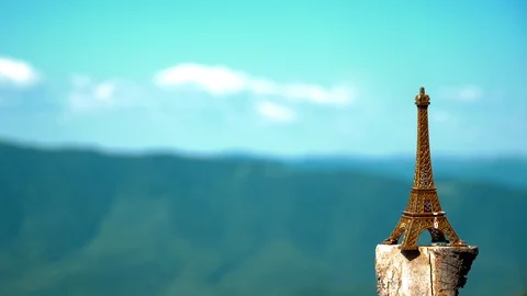 Eiffel tower on a mountain background. The figure of the Eiffel tower stands on Stock Footage 93452173