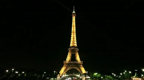 Eiffel Tower with Moving Light Beam and Carnival Ride Stock Footage 537817