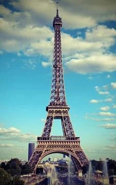 Eiffel Tower in Paris with white clouds in the sky and a vintage antique effe Stock Photos