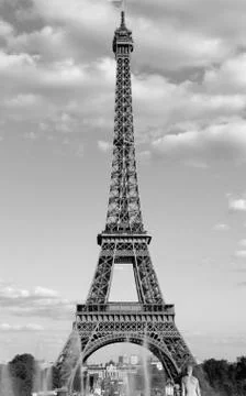 Eiffel Tower in Paris with white clouds in the sky and a black and white anti Fotos de archivo