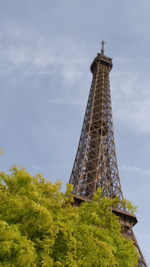 Eiffel Tower Peak Rising Above Lush Green Trees in Paris France Stock Footage 334360905