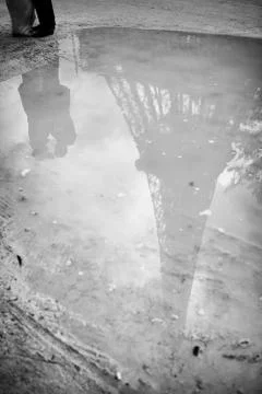 Eiffel tower reflected in puddle. spring in Paris. symbol of France. Stock Photos