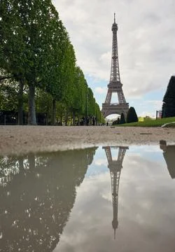 Eiffel tower reflecting in puddle after rain in paris Stock Photos