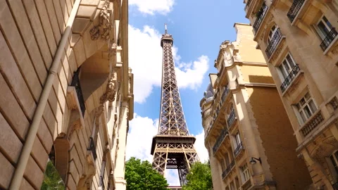 The Eiffel tower rises up through a row of buildings.Paris, France. Stock Footage 260700331
