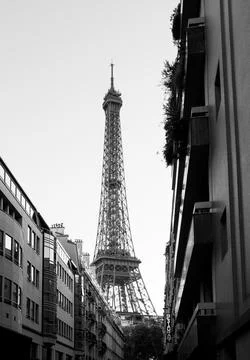 Eiffel Tower rising between buildings in Paris France Stock Photos