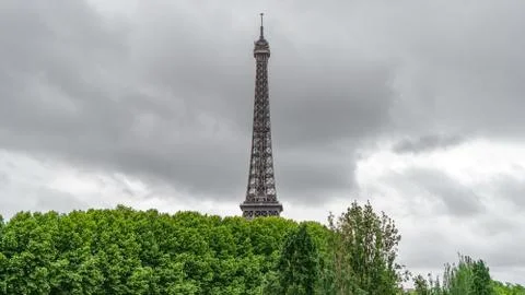 The Eiffel Tower rocket over the trees with stormy clouds Fotos Stock