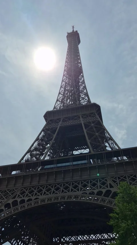 Eiffel Tower seen from below through trees on a summer day, Paris, France Stock Footage 346368471