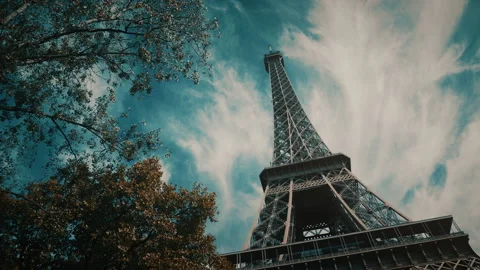 Eiffel tower seen from below with tree and cloudy sky Stock Footage 139757084