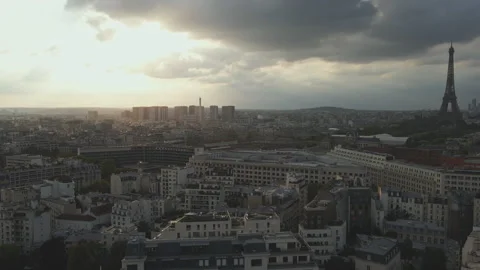 The Eiffel Tower is shrouded in shadow as the sun sets in Paris Stock Footage 244853545